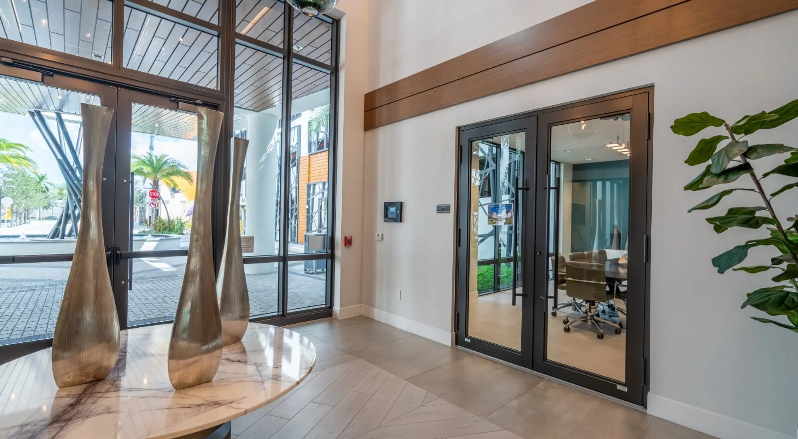 Commercial lobby in Florida with full-height storefront glazing and impact-rated double doors